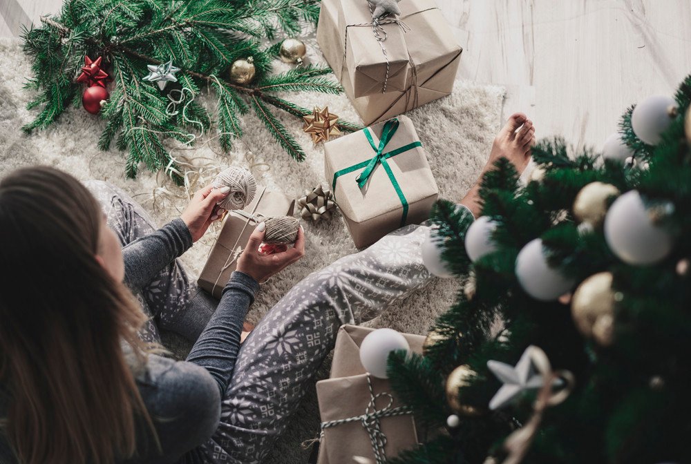 Woman decorating a christmas present